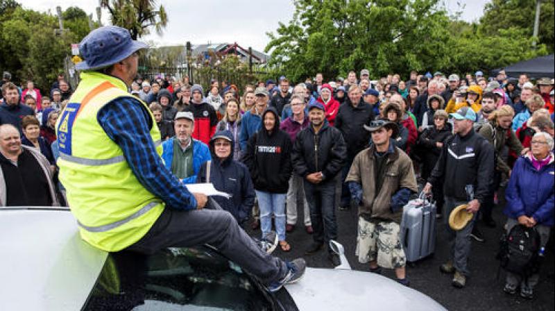 A large crowd of tourists and people wanting to leave Kaikoura are briefed about evacuation plans to board the HMNZS Canterbury, in Kaikoura, New Zealand. (Photo: AP)