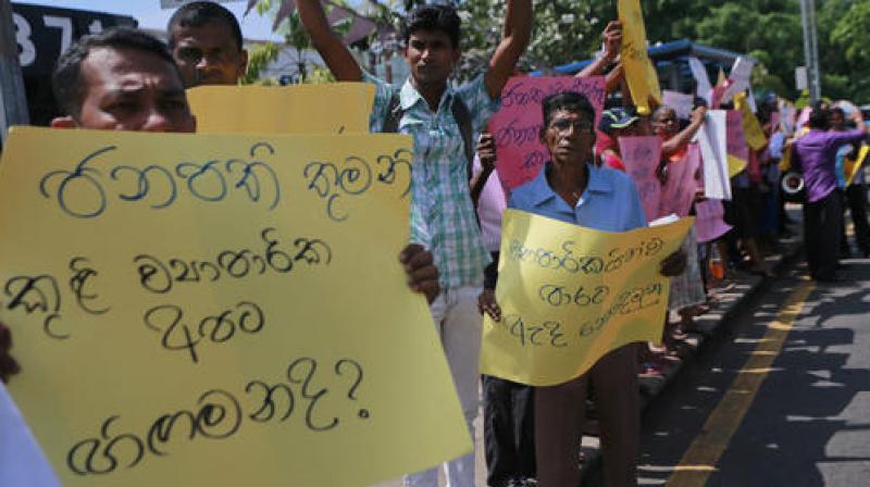 Sri Lankans residing in Salawa where their properties were damaged in an explosion in an army camp last July protest in Colombo, Sri Lanka. (Photo: AP)