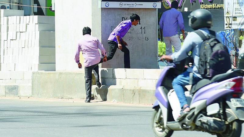 Men dangerously cross over a median as traffic zooms past them. (Photo: DC)