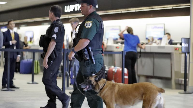 Law enforcement officers patrol the ticketing counters at the Tampa International Airport. (Photo: AP)