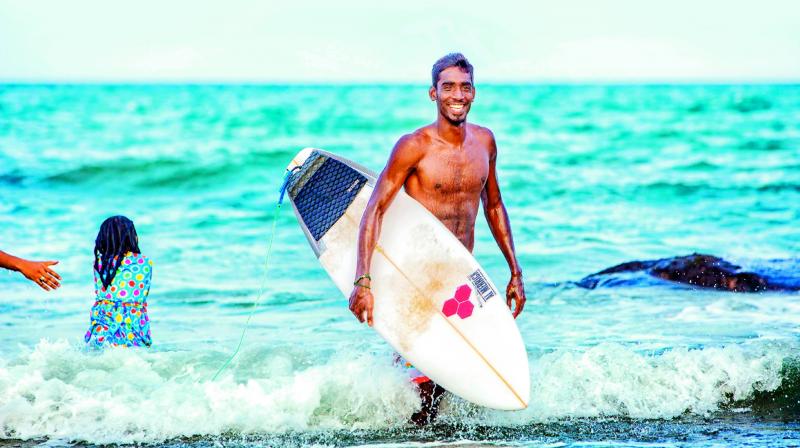 Riding the waves: 26-year-old fisherman-turned-surfer Sekar Patchai from Kovalam, near Chennai, was the first Indian surfer to participate in the ISA World SUP and Paddleboard Championship at Fiji.