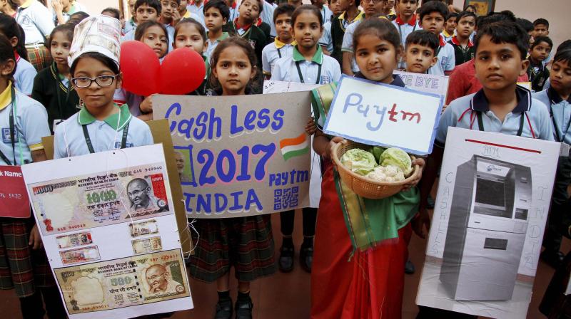 School Students hold Placards at a painting competition on Cash Less India, in Ahmedabad. (Photo: PTI)