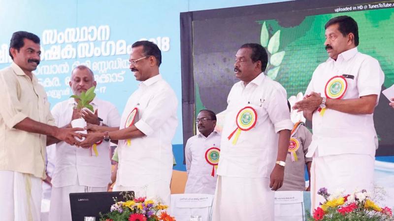 Excise Minister T. P. Ramakrishnan receives a sapling during the inaugural ceremony of state dairy farmers meet at Vadakara in Kozhikode on Thursday. 	(Photo: DC)