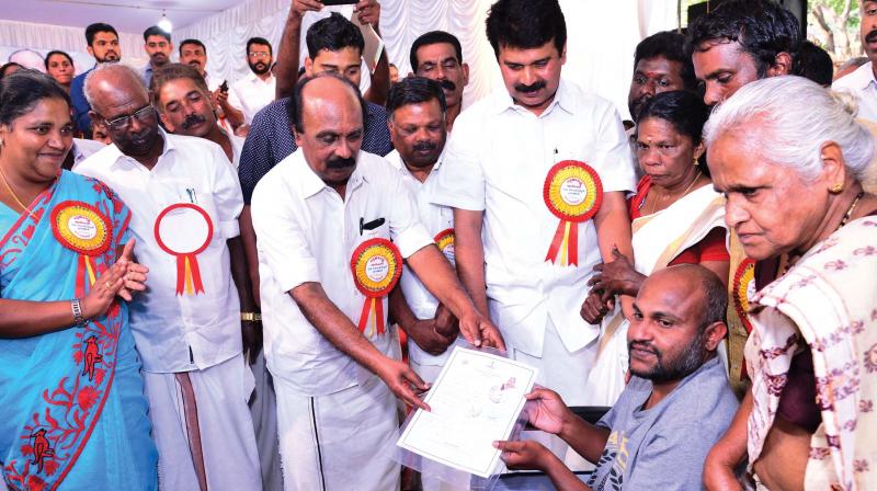 Revenue minister E. Chandrasekharan distributes title deeds in Kumily on Saturday. 	DC
