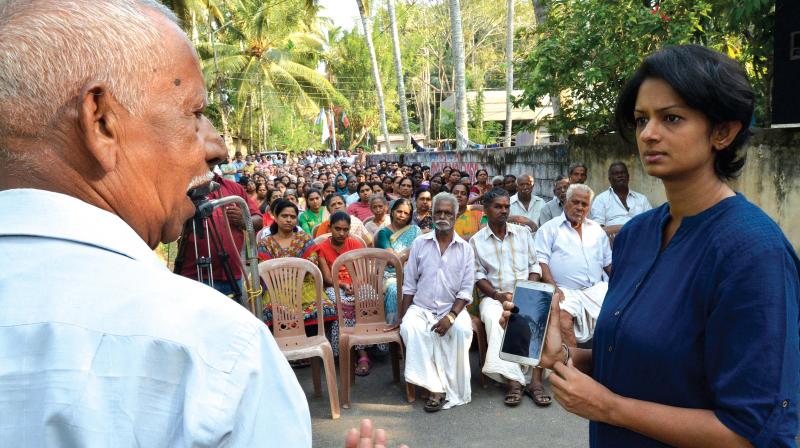 Sathyanandan, a native of Vayyamoola, interacts with District collector K. Vasuki on the land acquisition for the Thiruvananthapuram international airport development during a meeting convened by the collector on Sunday. (Photo: DC)