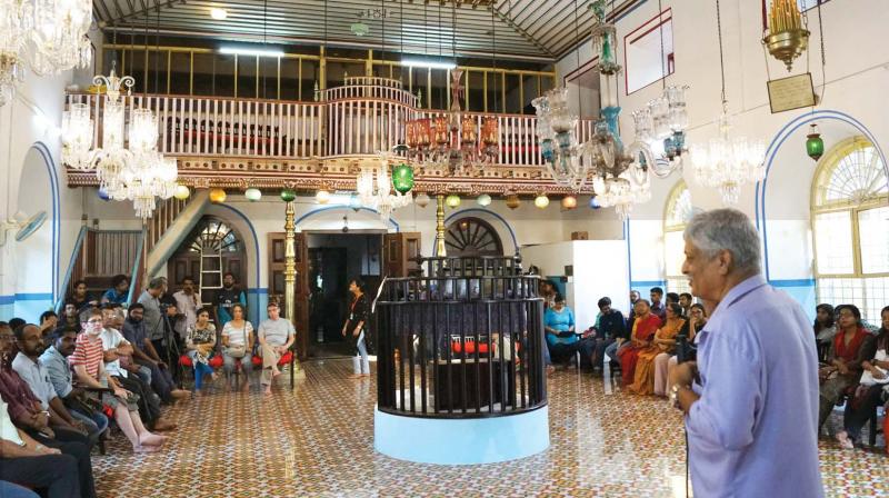 People listen to history of Jews at the India Heritage Walk Festival 2018 at Kadavumbagham synagogue.
