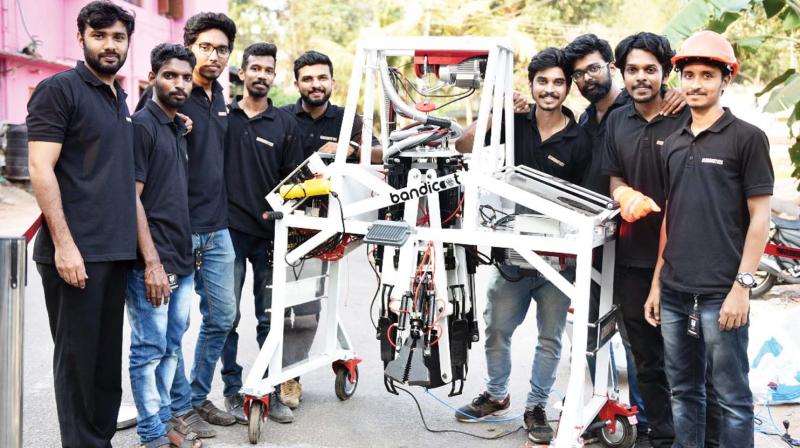 Members of Genrobotics team with the sewage cleaning machine Bandicoot that cleans manholes without human intervention.
