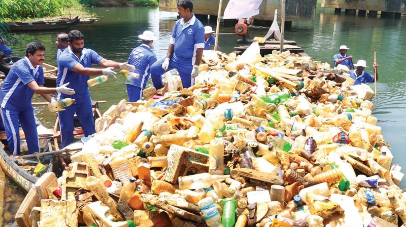 Volunteers of NGO Save Piravom Puzha recover non-biodegradable waste from the river during the campaign.