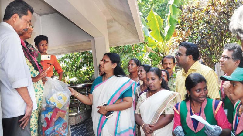 Haritha Keralam Mission vice-chairperson T.N. Seema with the Green Beacon team collects plastic waste from a house in Temple ward.