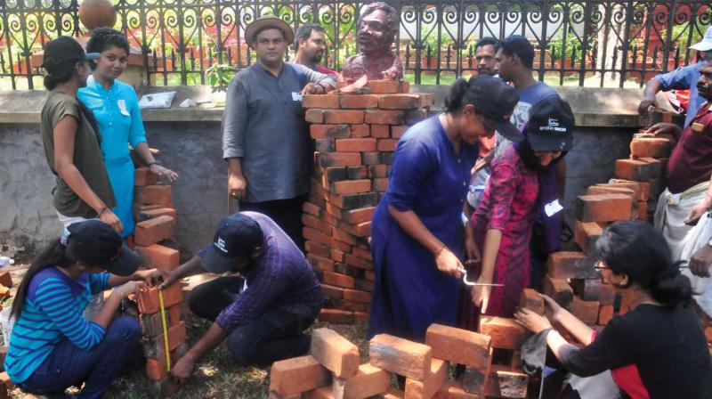 Prof. Manoj Kumar Kini, urban designer and faculty at CET and his architecture students giving final touches to The Truth, the brick installation set up at Kowdiar in Thiruvananthapuram on Saturday. 	(Photo: A.V. MUZAFAR)