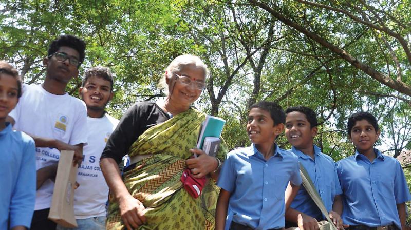 Activist Medha Patkar walks with children through Maharajas College campus to attend National Environmental Summit organised by Save Western Ghats Movement in Kochi on Saturday.   ([Photo:  SUNOJ NINAN MATHEW. )