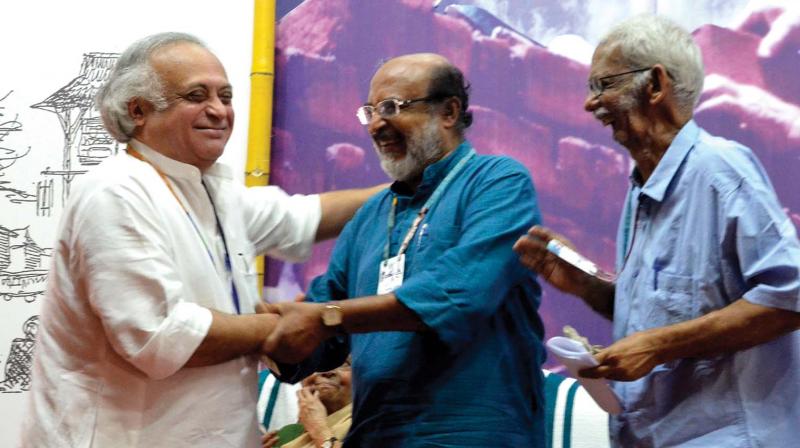 Former union minister Jairam Ramesh greets finance minister T.M. Thomas Issac during the inauguration of the birth centenary of late architect Laurie Backer on Sunday. T.R. Chandradath looks on.  (Photo: Peethambaran Payyeri)
