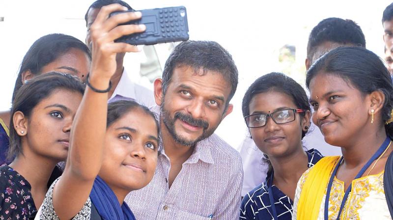 Carnatic musician T.M. Krishna poses for a groupie with visitors at Krithi International Festival of Books and Authors in Kochi on Thursday. 	 SUNOJ NINAN MATHEW.