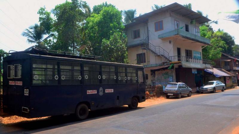 Police bus gives cover for the T.P. Chandrasekharan memorial column