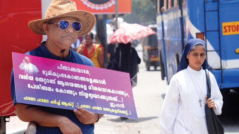 Professor Joseph Varghese holds a placard demanding the introduction of Church Act in the wake of the land deal controversy involving Ernakulam-Angamaly Archdiocese of Syro Malabar Church in Kochi.  FILE