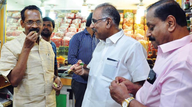 Excise minister T.P. Ramakrishnan and transport minister A.K.Saseendran taste sweets during a visit to SM Street in Kozhikode on Friday.(Photo: Viswajith.K)