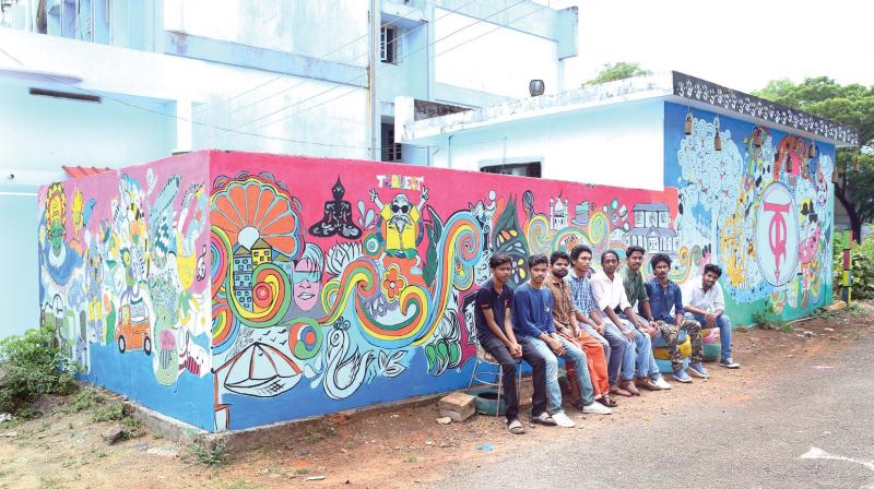Students of BTech (Instrumentation) at Cochin University of Science and Technology beside their wall painting.