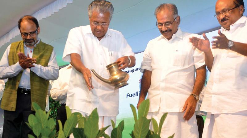 Chief Minister Pinarayi Vijayan launches first CNG fuel station at Kalamassery by watering saplings instead of lighting a traditional lamp on Thursday. IOC chief general Manager (Kerala) P.S Mony , transport minister A.K. Saseendran and Prof K.V Thomas, MP, are also seen.  (Photo: SUNOJ NINAN MATHEW)