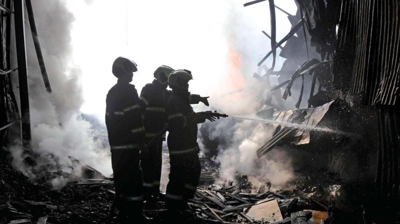Fire personnel douse a major fire which broke out at Mandala Mankhurd in Mumbai on Sunday. 	(Photo: PTI)
