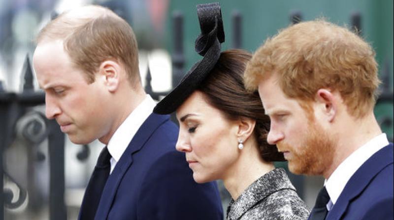 From left, Britains Prince William, Kate the Duchess of Cambridge and Prince Harry stand together after William laid a wreath after arriving for a Service of Hope at Westminster Abbey. (Photo: AP)