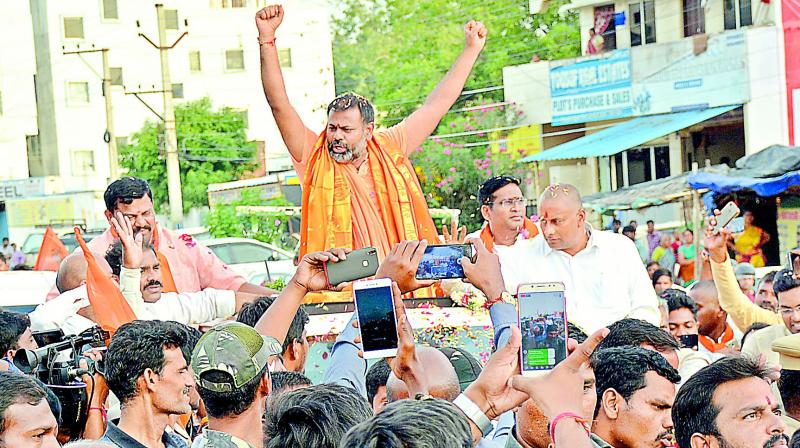 Followers welcome Swami Paripoornananda as he entered the city on Tuesday