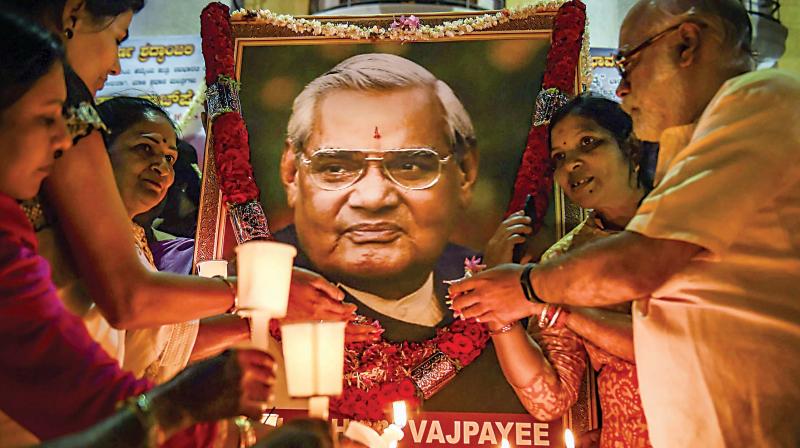 BJP supporters (above) hold candles to pay tribute to former Prime Minister Atal Behari Vajpayee in Bengaluru on Friday. 	 PTI