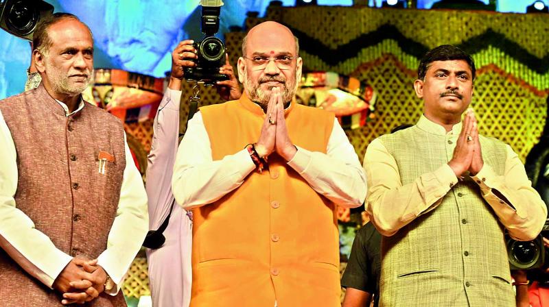 BJP national president Amit Shah attends an event in Hyderbad. BJP state president Dr K. Laxman and BJP All India secretary Muralidhar Rao are also seen.  (Gandhi)