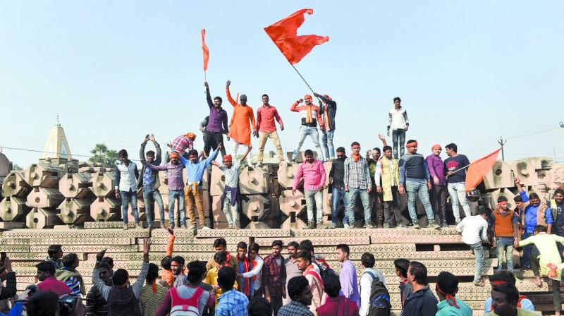 Supporters at Kar Sevak Puram workshop participate in Dharam Sabha to push for the construction of the Ram temple, in Ayodhya on Sunday.  	 (PTI)