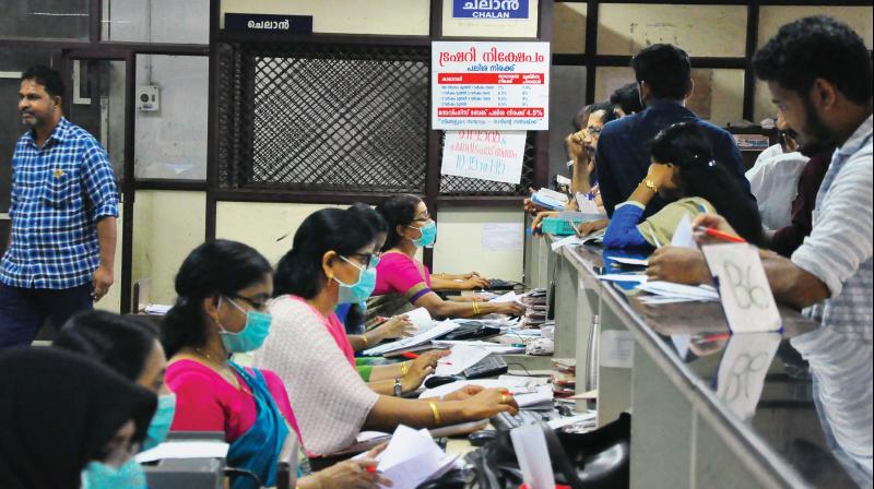 Employees wear masks during work due to Nipah virus scare at the District Treasury, Civil Station, Kozhikode on Wednesday (Photo: Viswajith.K)