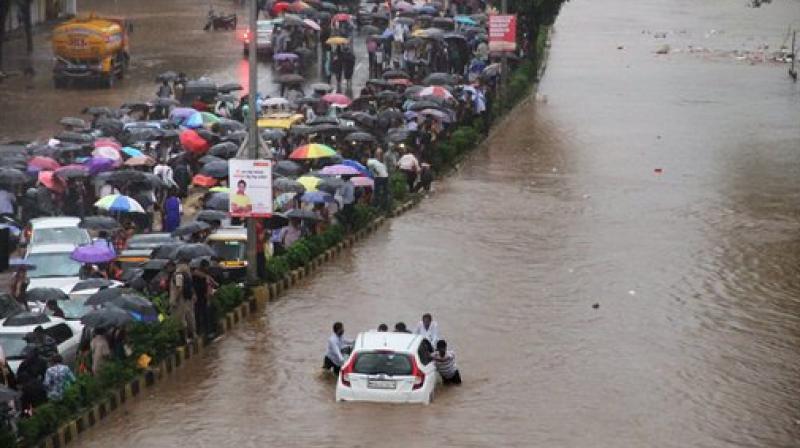 Vehicles stuck at a flooded street after heavy rains in Thane, Mumbai on Tuesday. (Photo: PTI)