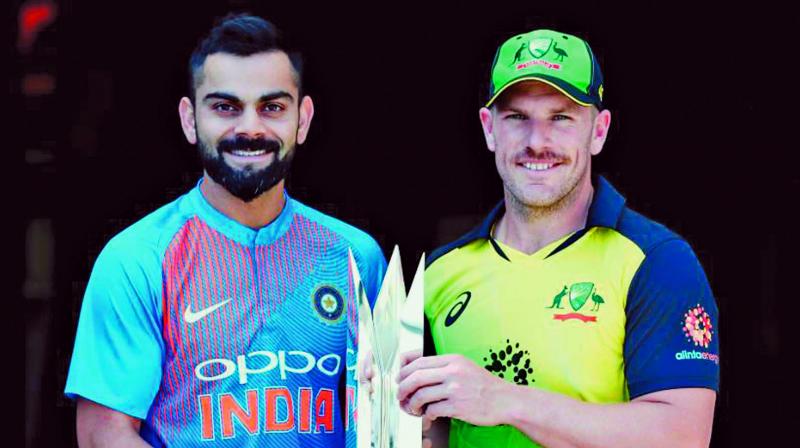 India captain Virat Kohli and his Aussie counterpart Aaron Finch pose with the T20 trophy ahead of the series opener at the Gabba. (Photo:  ICC)