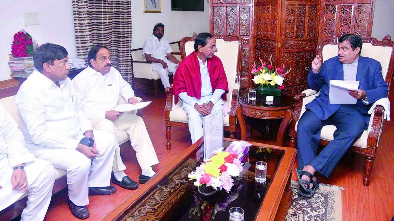 Chief Minister K. Chandrasekhar Rao interacts with Union minister Nitin Gadkari as MP B. Vinod Kumar and TS minister T. Nageswara Rao look on, in New Delhi on Monday.
