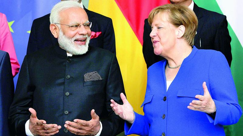 Prime Minister Narendra Modi and German Chancellor Angela Merkel during the agreement signing ceremony in Berlin on Tuesday. (Photo: PTI)