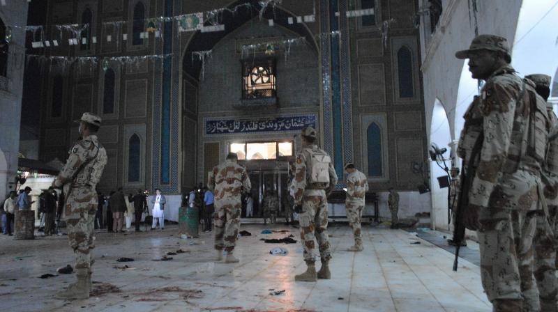 Pakistani para-military soldiers stand alert after a deadly suicide attack at the shrine of famous Sufi Lal Shahbaz Qalandar in Sehwan, Pakistan. (Photo: AP)