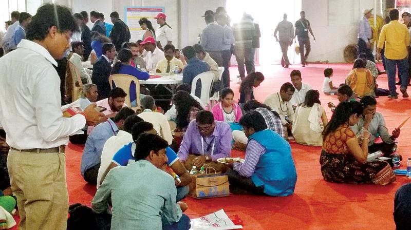 Visitors eat on the floor due to lack of seating. (Photo: DC)