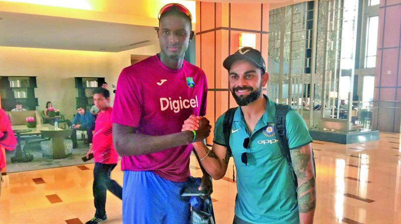 West Indies captain Jason Holder and his Indian  counterpart Virat Kohli pose upon Team Indias arrival in Port Of Spain on Wednesday. Kohli & Co. will play five ODIs and a T20. The series begins on Friday. (Photo: BCCI)