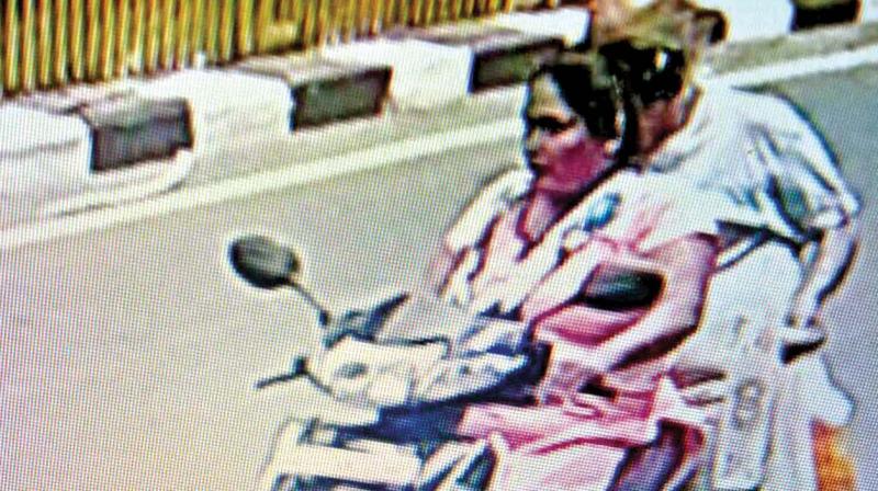 A CCTV grab showing Asha riding her scooter with an elderly man suspected to be one of her victims. (Photo: DC)