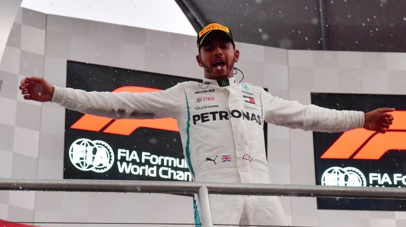 The defending four-time champion took full advantage of a heavy downpour during which title rival and fellow-four-time champion Sebastian Vettel of Ferrari crashed out of contention.(Photo: AFP)