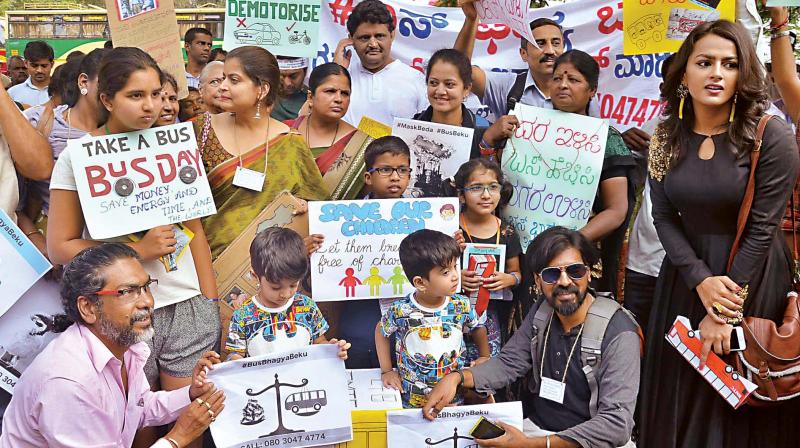 Members of Bus Prayanikara Vedike under a banner Bus Bhagya Beku stage a dharna in Shanthinagar on Saturday. (Photo: KPN)