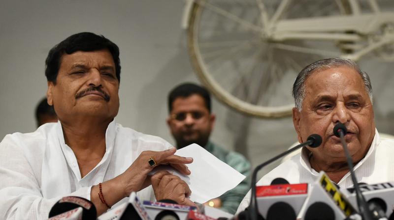 Samajwadi Party supremo Mulayam Singh Yadav addresses the media with partys UP President Shivpal Yadav at a press conference at the party office in Lucknow on Tuesday. (Photo: PTI)