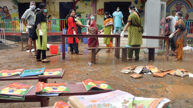 A group of teachers from Govt. H.S.S Maneed volunteered for cleaning Eloor Vadakkumbhagom, S.H.J.U.P School premises and equipment before the school reopening on Wednesday. The school was nearly submerged during the floods.(Photo: SUNOJ NINAN MATHEW)