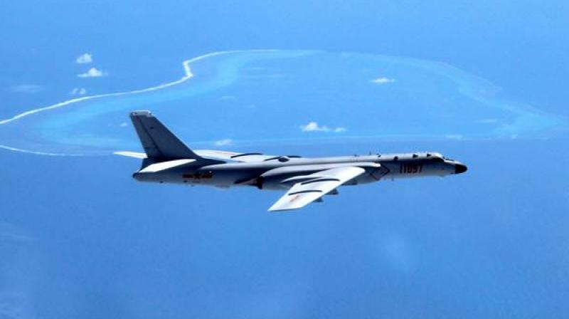A Chinese H-6K bomber patrols the islands and reefs in the South China Sea. China is pitted against smaller neighbors in multiple disputes over islands, coral reefs and lagoons in waters crucial for global commerce and rich in fish and potential gas and oil reserves in the South China Sea. (Photo: AP)