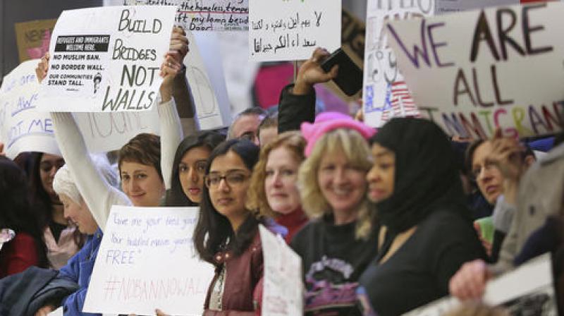 People show signs at the Indianapolis International Airport during a protest against President Donald Trumps executive order temporarily suspending all immigration for citizens of seven majority Muslim countries for 90 days. (Photo: AP)