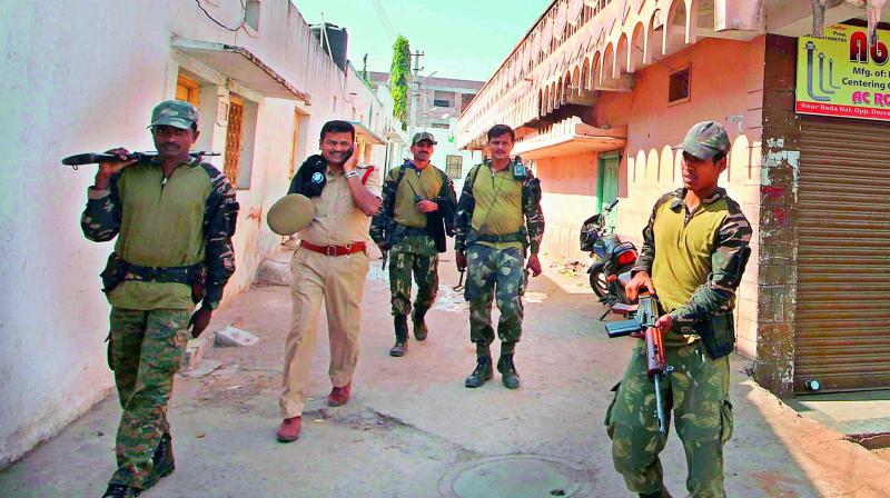 Security personnel march through a locality in the vicinity of the National Police Academy in Hyderabad on Thursday. Security has been heightened in view of the Prime Ministers visit to the NPA that begins on Friday.  (Photo: DC)