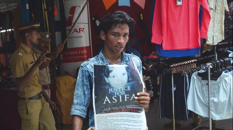 Police removes a youth who tried to forcibly close down the shops at Saphalyam complex in Palayam in Thiruvananthapuram on Monday.  (Photo: Peethambaran Payyeri)