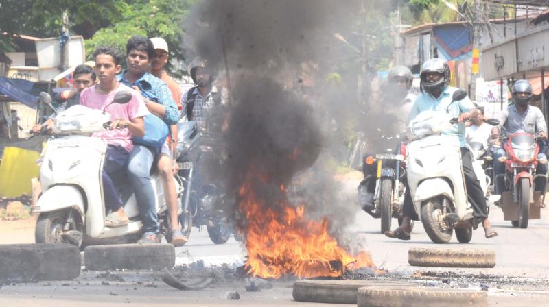 Calicut-Nilambur-Gudallur interstate highway blocked by burning tyres at Manjeri, Malappuram on Monday.