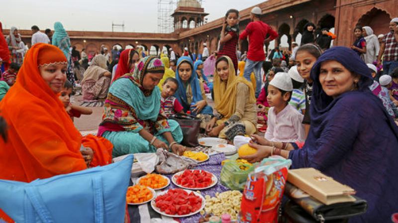 An Indian Muslim family prepare food to eat as they wait for an announcement for them to break their day-long fast at Jama Masjid in New Delhi, India, Wednesday, June 14, 2017. (Photo: AP)