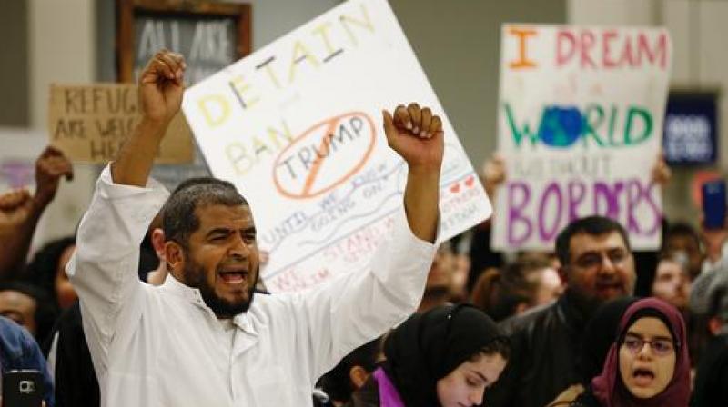 Protestors demonstrate against President Donald Trumps travel ban barring citizens of seven predominantly Muslim nations entry into the U.S., at Dallas/Fort Worth International Airport, Saturday. (Photo: AP)
