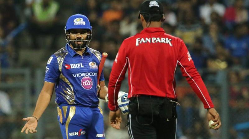 During the tenth over of the Mumbai Indians innings, Rohit Sharma was given out LBW by umpire CK Nandan, following which the batsman was seen gesturing angrily and showing his bat to the umpire as he walked away. (Photo: BCCI)