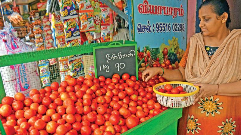 A woman purchases tomatoes at a retail shop on Thursday. (Photo: DC)